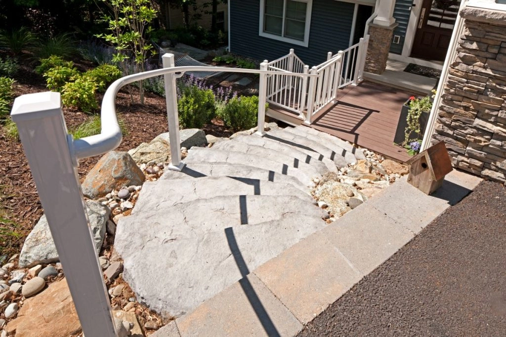Curved concrete staircase with white railings, leading to a landscaped entrance in Catonsville, Baltimore County.