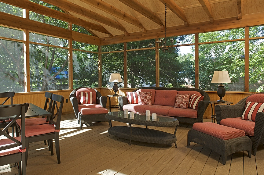 Bright and inviting screened porch featuring comfortable seating and natural light, perfect for relaxation.