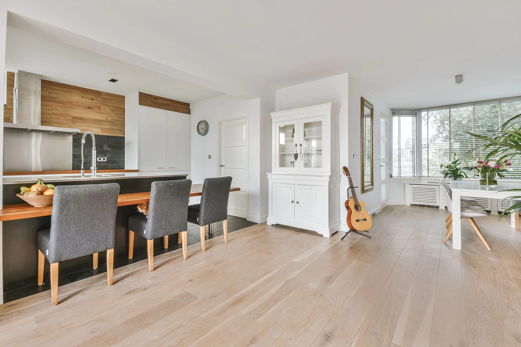 Open dining room with wide-plank wood-look flooring running through the space