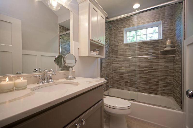 Modern bathroom featuring a stylish tub, sleek tile work, and elegant fixtures, ideal for remodeling inspiration.
