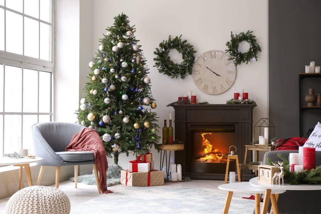 Festively decorated living room with a Christmas tree, fireplace, and cozy furnishings for holiday gatherings.