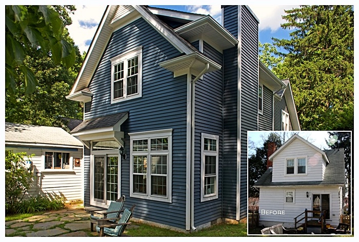 Two-story blue house with white trim, featuring large windows and a modern design in Catonsville.